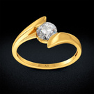 Gold twisted solitaire diamond ring on dark display background with soft glow
